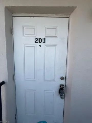 View of exterior entry with stucco siding