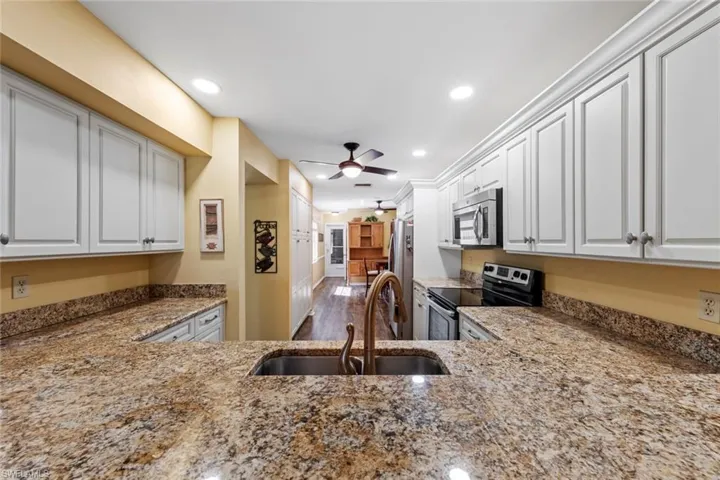 Breakfast bar looking through kitchen to door to garage