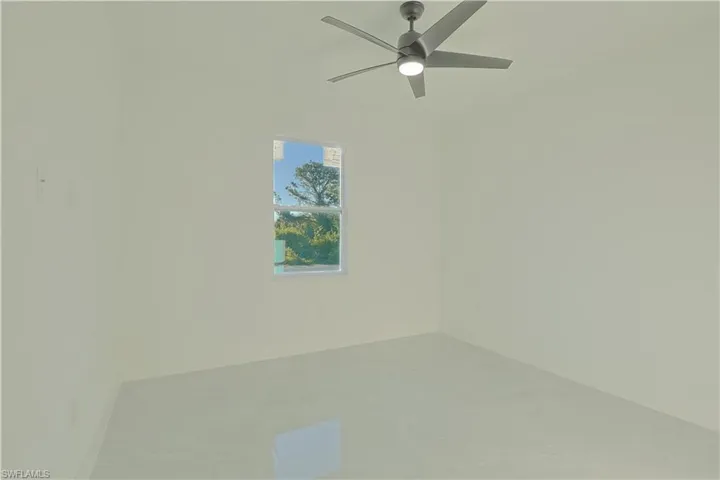 Empty room with baseboards and ceiling fan