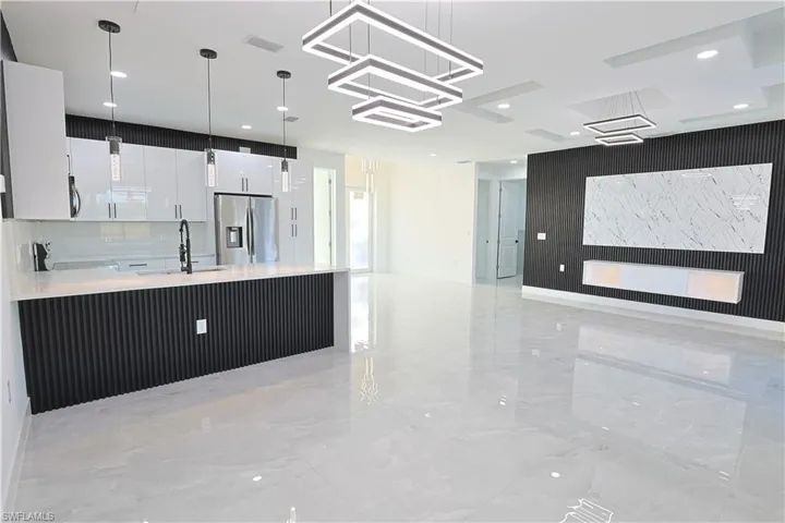 Kitchen featuring a sink, stainless steel appliances, visible vents, and open floor plan