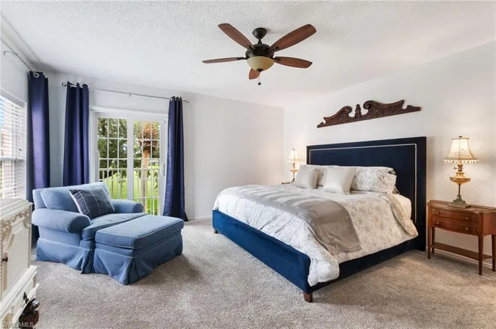 Gorgeous views of the golf course from primary bedroom. Shown here fully furnished