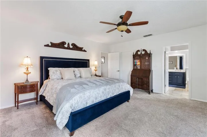 Primary bedroom with walk-in closet and ensuite bathroom.  Shown here fully furnished