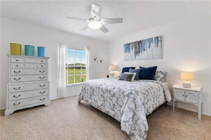 Large guest bedroom with views of golf course.  Shown here fully furnished