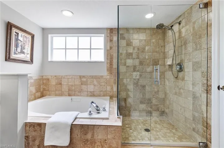 Master bathroom features soak-in tub and large shower