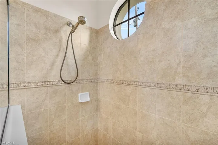 Bathroom featuring tiled shower