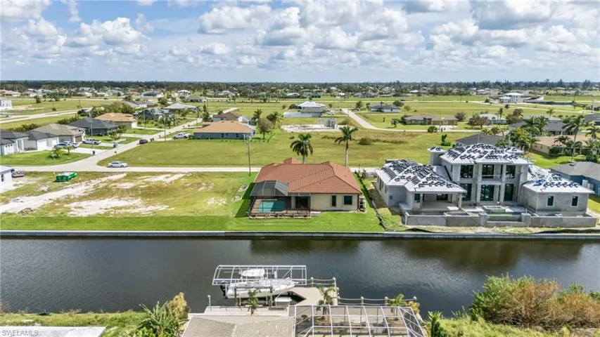 Birds eye view of property with a water view