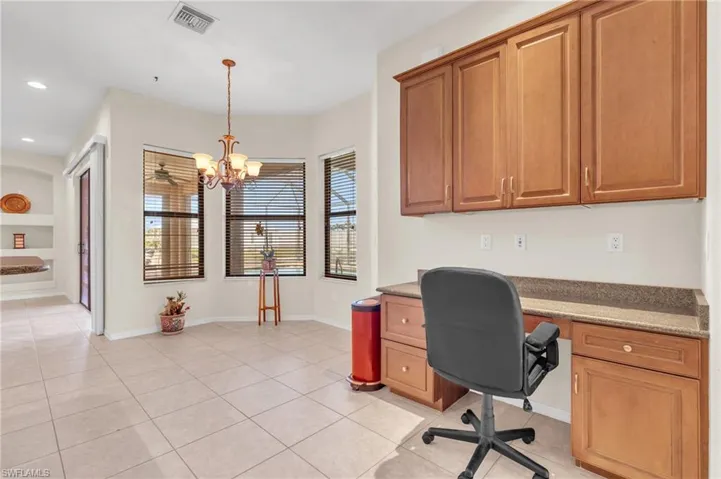Tiled office space featuring built in desk