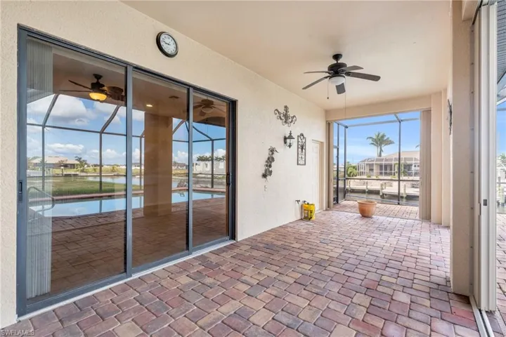 Unfurnished lanai featuring ceiling fan and a water view