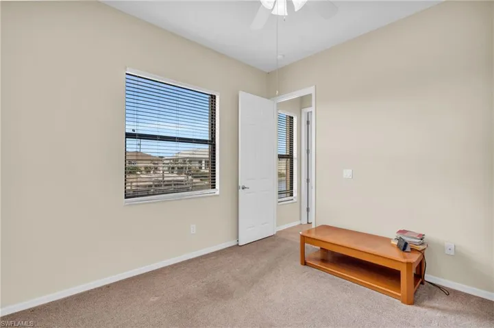Unfurnished room with ceiling fan and light colored carpet