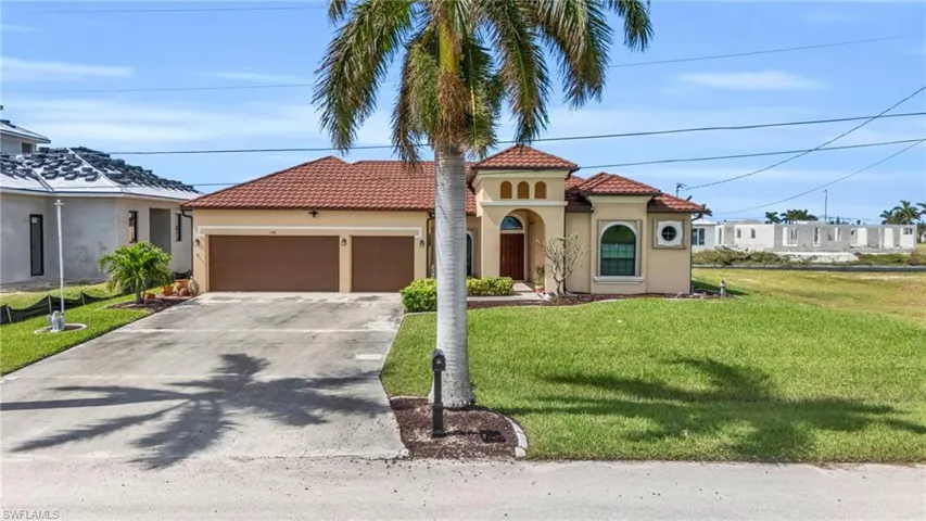 Mediterranean / spanish-style house featuring a garage and a front yard