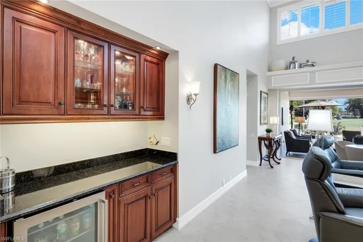 Dry bar with wine fridge and storage.