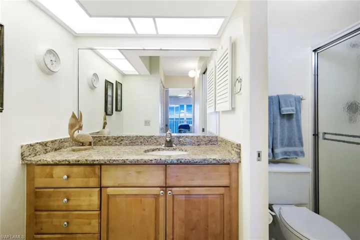 Ensuite bathroom featuring vanity and a shower stall