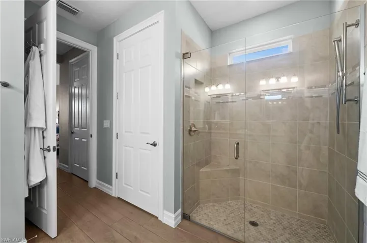 Bathroom featuring walk in shower and hardwood / wood-style flooring