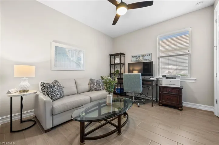 Living room featuring light hardwood / wood-style floors and ceiling fan