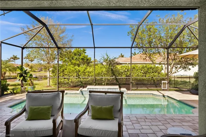 View of swimming pool featuring a patio and a lanai