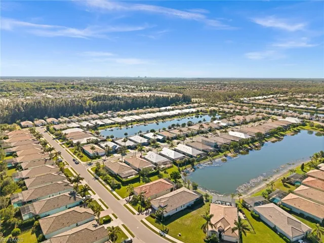 Birds eye view of property with a water view