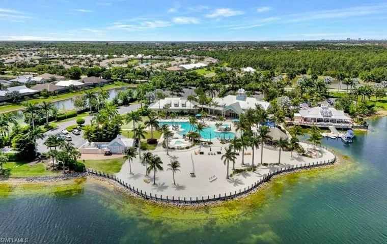 Birds eye view of property with a water view