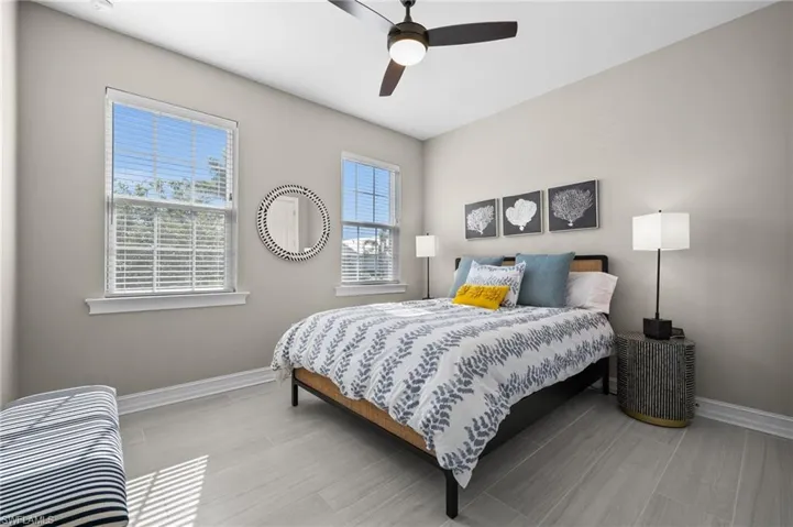Bedroom with ceiling fan and light hardwood / wood-style floors