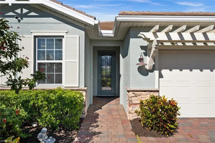 View of exterior entry featuring a garage