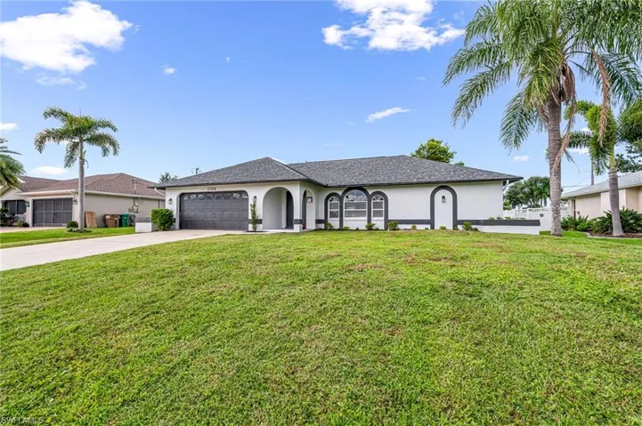 Single story home with a front lawn and a garage
