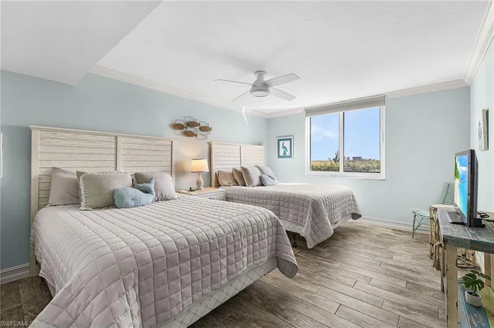 The spacious guest bedroom has two queen beds and a walk-in closet.