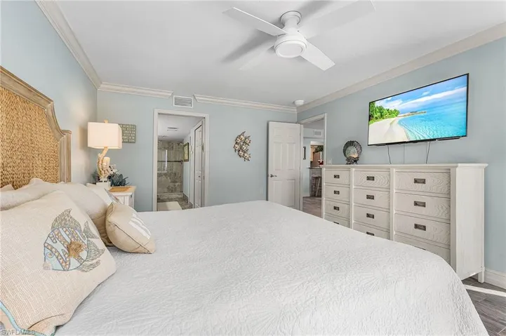 The primary bedroom is done in a soothing coastal decor, with ensuite bath.