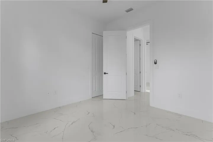 Unfurnished room featuring light marble finish flooring