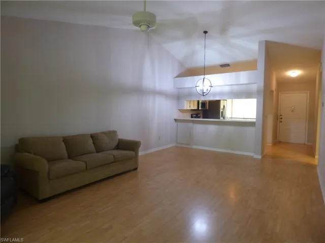 View from lanai into living & kitchen area as well as front door entry