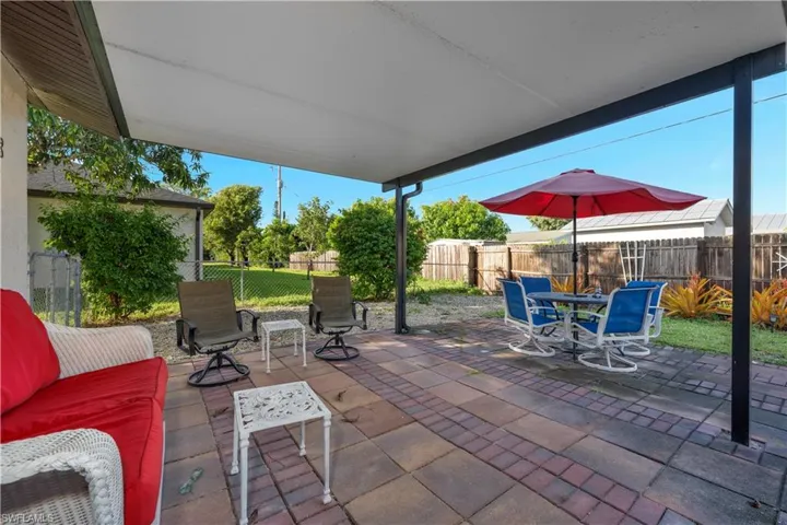 Fenced backyard with a patio area and outdoor dining area