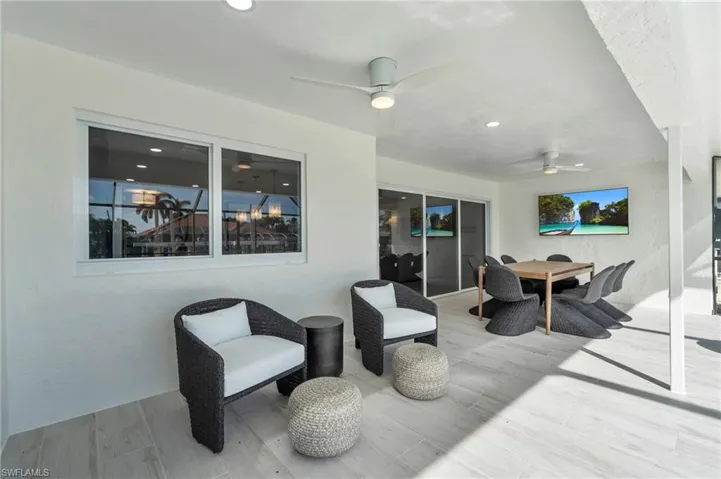 Spacious covered patio offering comfortable seating and an outdoor dining area - Virtually Edited Image