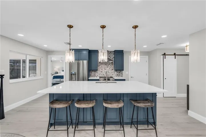 Kitchen island with seating overlooks the open living area - Virtually Edited Image
