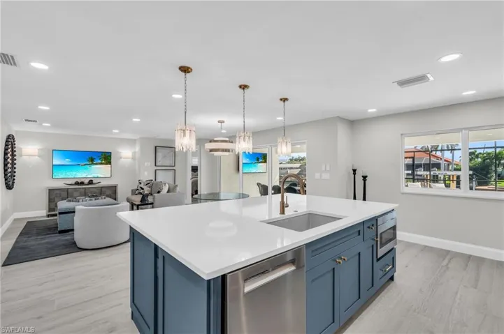 Open concept living featuring a stylish kitchen island- Virtually Edited Image