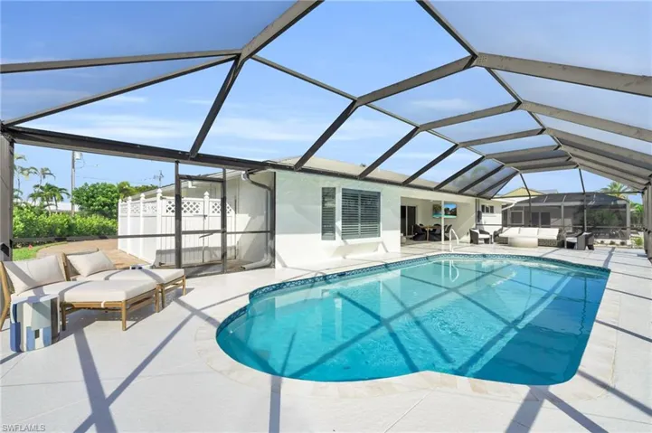 Outdoor oasis featuring a sparkling screened pool and spacious patio - Virtually Edited Image