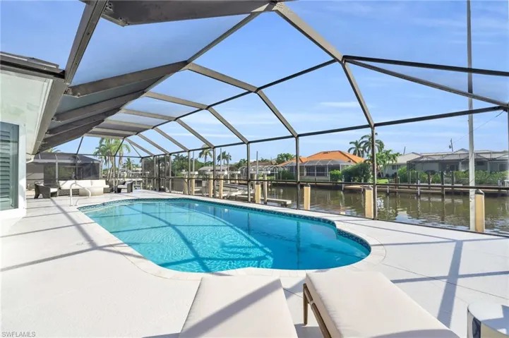 Private screened pool with waterfront views for outdoor enjoyment - Virtually Edited Image