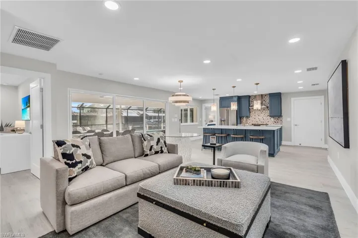 Spacious living area furnished for comfortable living and entertaining - Virtually Edited Image