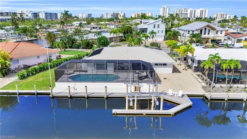 Exceptional waterfront residence offering a private pool, boat dock, and direct water access  - Virtually Edited Image
