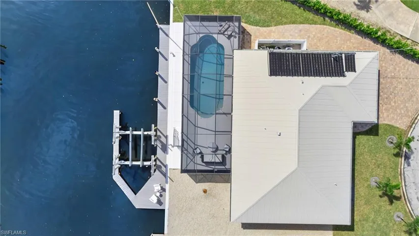 Top-down perspective highlighting its waterfront location, pool, and boat lift - Virtually Edited Image