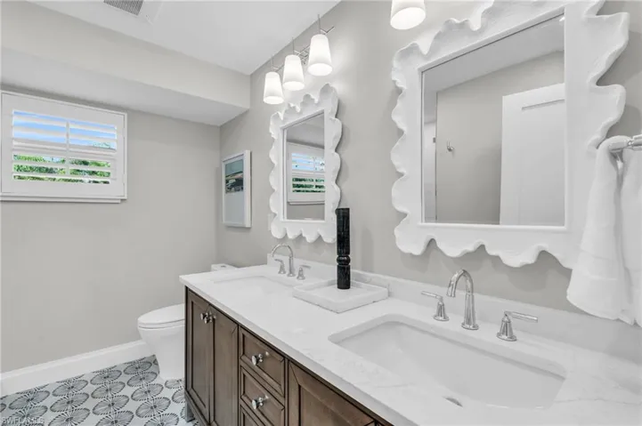Guest Bathroom Well-designed bathroom offering a functional and elegant space with a double vanity  - Virtually Edited Image