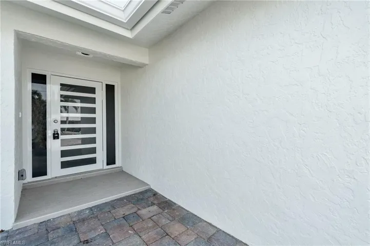 Bright and welcoming front entrance with ample natural light - Virtually Edited Image