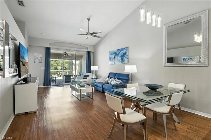 Dining room featuring a ceiling fan, dark wood finished floors, and high vaulted ceiling