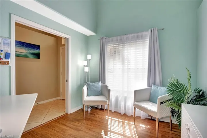 Living area featuring baseboards and light wood-type flooring