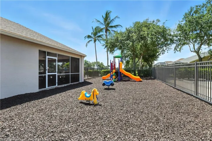 View of playground with a sunroom