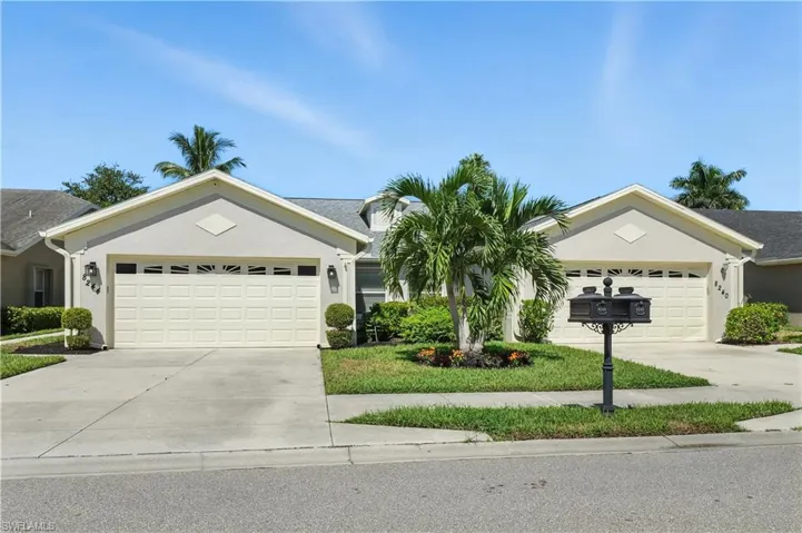 Ranch-style home featuring an attached garage, concrete driveway, and stucco siding