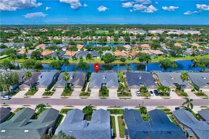 Aerial view of property's location with a large body of water and nearby suburban area