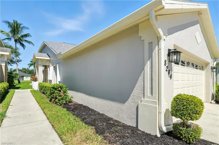 View of home's exterior with stucco siding and a garage