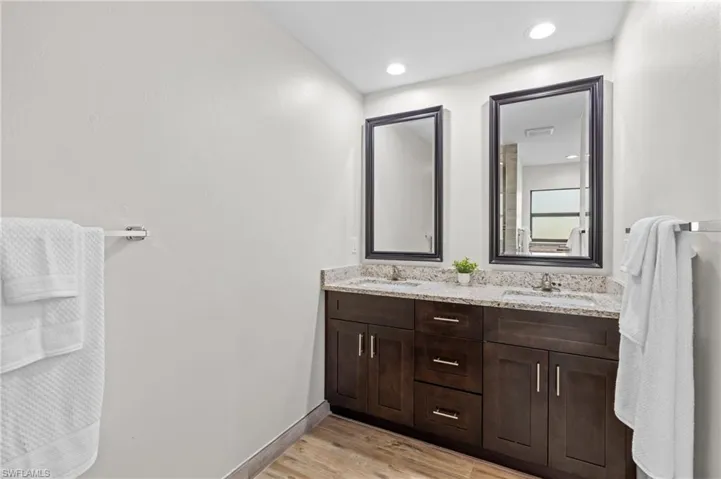 Bathroom with hardwood / wood-style floors and vanity