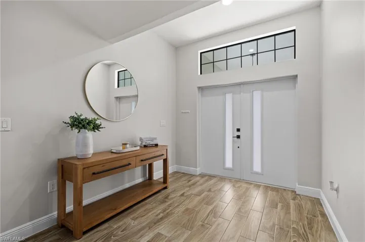 Entryway with a healthy amount of sunlight and a high ceiling