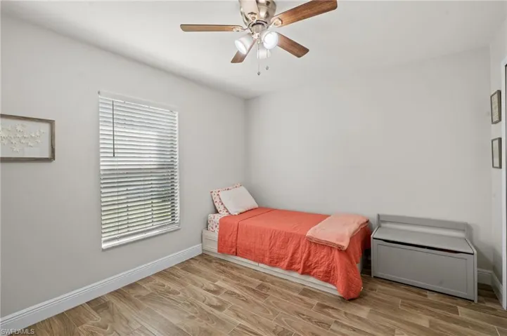 Bedroom with ceiling fan and light hardwood / wood-style floors