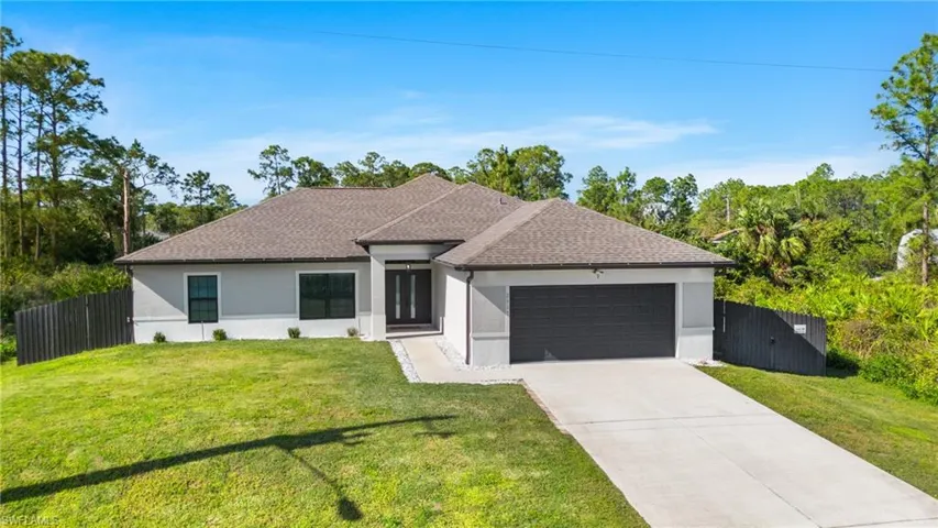 View of front of house with a front yard and a garage