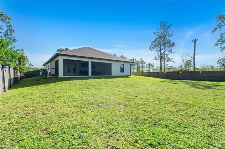 Back of property with a lawn